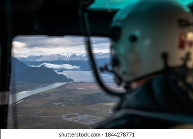 POV Over Helicopter Pilot's Shoulder Flying Over Mountain Valley