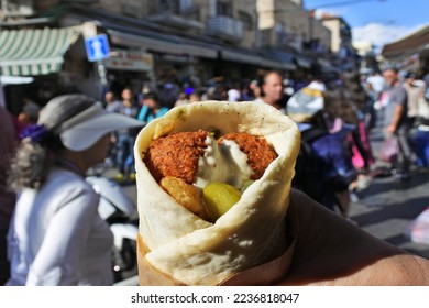 POV (personal prespective point of view) Person holding a Falafel dish in Laffa (Middle Eastern bread) at Mahane Yehuda Market Jerusalem Israel - Shutterstock ID 2236818047