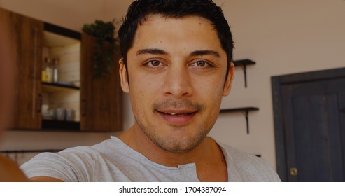 POV PHONE CAMERA VIEW Handsome Hispanic man having a video call with friends or family. Stay home, quarantine life - Powered by Shutterstock