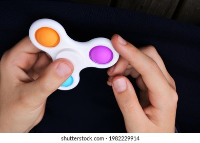 POV (point of view) of child hands playing with pop it fidget spinner toy. - Powered by Shutterstock