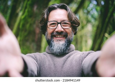 Pov point of view of man opening arms to hug and embrace you. People and love concept. Green nature park in background. Happiness and care. Bearded and eyewear happy senior man outdoor portrait - Powered by Shutterstock