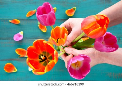 POV (point Of View) Of A  Woman Hands Organizing And Assorting Tulip Flowers Bouquet. Women Holiday Concept. Copy Space