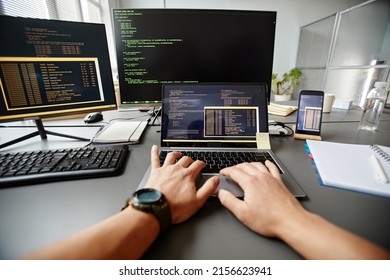POV of QA engineer typing on keyboard while using computer at workplace in office, copy space