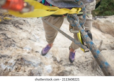 POV: Rock Climber Hangs From Rope And Gear High Above The Ground