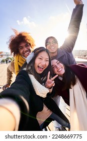 POV selfie of mixed race group of young people looking at camera laughing enjoying their day outdoors at the city. Vertical. - Shutterstock ID 2248669775