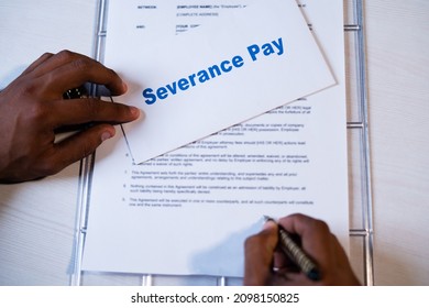 POV shot of employee checking severance pay notice and signing on termination agreement or contract - concept of job loss during coronavirus covid-19 pandemic