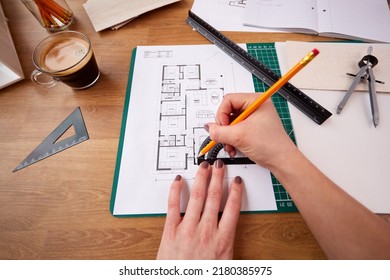 POV Shot Of Female Architect Working In Office Measuring Plans For New Building