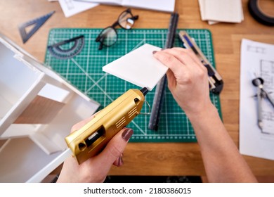 POV Shot Of Female Architect Working In Office Making Model Of New Building