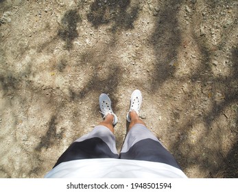 POV Shot. Male Runner Looking Down At His Feet, Standing On Dirty Road, Ready For Run.