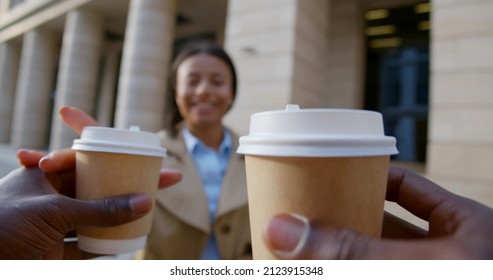 Pov Shot Of Man Bring Takeaway Coffee To Colleague Outdoors. Businesswoman Drink Coffee-to-go With Coworker Outside Business Center