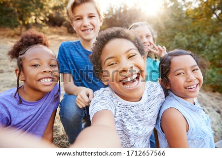 POV Shot Of Multi-Cultural Children Posing For Selfie With Friends In Countryside Together
