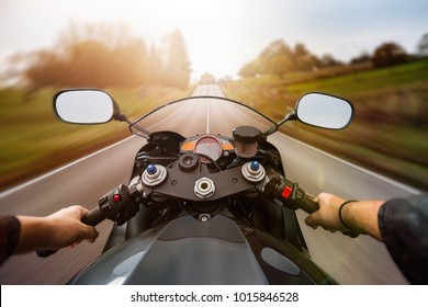 POV Shot Of Young Man Riding On A Motorcycle. Hands Of Motorcyclist On A Street