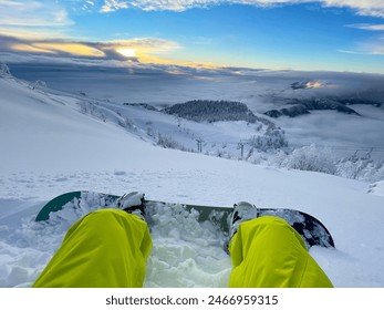 POV: Stunning view of idyllic wintry scenery as you sit in deep powder snow during a fun snowboarding trip to the beautiful Slovenian mountains. Breathtaking shot of the snowy Slovenian backcountry. - Powered by Shutterstock