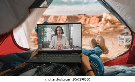 POV of a Tourist Making a Video Call with a Friend or a Colleague on Laptop Computer. Traveller Resting in a Tent on Top of a Rocky Mountain. Adventurous Hiker Living in Nature.