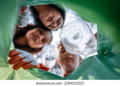 POV view from inside of the bag young volunteer teenagers collect plastic waste from nature eco awareness and recycle concept - Powered by Shutterstock