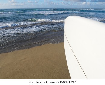 POV View. Surfer Stands With White Surfboard On Tropical Beach Against Ocean. Copy Space.