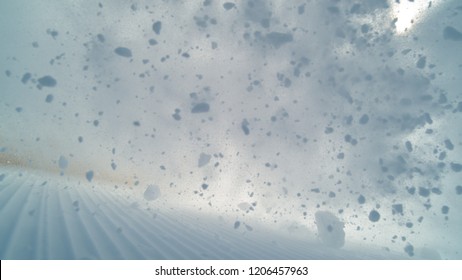 POV: Wild avalanche rushes down the groomed ski slopes in the beautiful Alps and covers the camera with fresh powder snow. Stunning shot of heaps of snow speeding down popular ski resort in Slovenia. - Shutterstock ID 1206457963