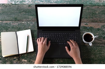 POV Of Women's Hands At A Rustic Table With A Laptop, An Open Notebook With A Pencil And A Coffee In A Cup.