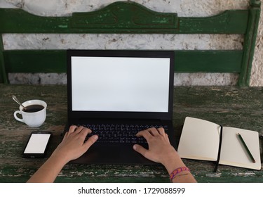 POV Of Women's Hands At A Rustic Table With A Laptop, An Open Notebook With A Pencil And A Coffee In A Cup.