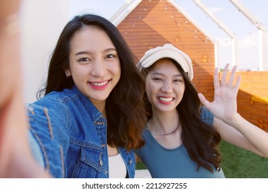 POV Of Young Asian Woman With Friend Holding Phone  Selfie Making Video Call