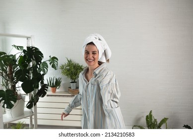 POV Of Young Happy Woman Or Girl Dancing In The New Apartment In Boyfriend Shirt And Towel On Her Head Happy That She And Her Boyfriend Have They Own Home. With Motion Blur Film Noise Real People.