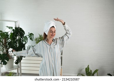 POV Of Young Happy Woman Or Girl Dancing In The New Apartment In Boyfriend Shirt And Towel On Her Head Happy That She And Her Boyfriend Have They Own Home. With Motion Blur Film Noise Real People.