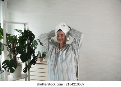 POV Of Young Happy Woman Or Girl Dancing In The New Apartment In Boyfriend Shirt And Towel On Her Head Happy That She And Her Boyfriend Have They Own Home. With Motion Blur Film Noise Real People.