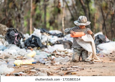 Poverty in India, a child collects garbage in a landfill site, Concept of livelihood of poor children.Child labor. Child labor,  human trafficking, Poverty concept. - Shutterstock ID 1731883114