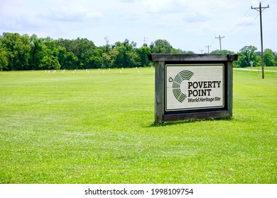 Poverty Point, LA -2021: Poverty Point State Historical Site Is A Prehistoric Monumental Earthworks Site Constructed By Poverty Point Culture. World Heritage Site Sign, White Wood Post Markers Circle.