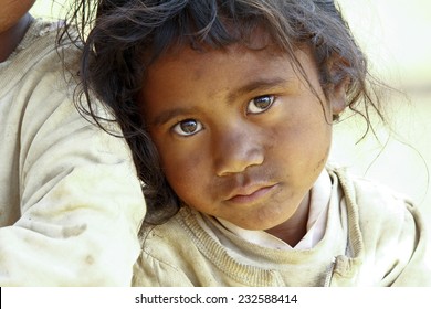 Poverty, portrait of a poor little African girl lost in deep thoughts