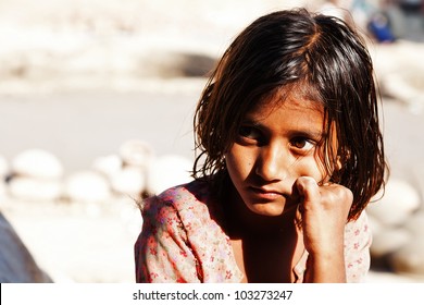 poverty, portrait of a poor little Indian girl lost in deep thoughts