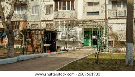 Poverty in post soviet block of flats and shot of entrance in the building. Soviet architecture district with apartments.
