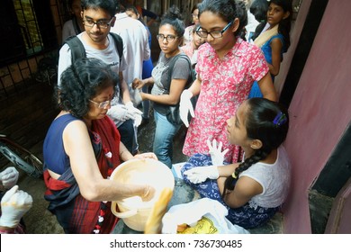 POWAI, MUMBAI, MAHARASHTRA, INDIA - OCTOBER 16, 2017 - A Social Worker/ Artist Is Seen Preparing Paint In A Chawl Area, As Part Of A Clean Up Initiative Taken Up For The Rehabilitation Of Slum Kids.