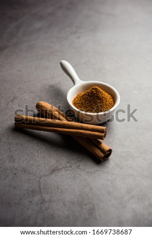 Powder cinnamon and sticks also known as Dalchini or Dalcheenee masala from India, selective focus