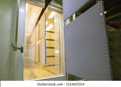 Powder Coating Line In An Electrostatic Field. The Metal Panel Is Fed Into The Spray Booth. Automatic Line, Modern Industrial Equipment.