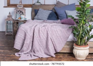Powder Color Knitted Blanket On The Bed