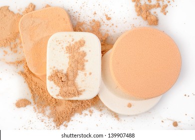powder and cosmetic sponges on white background