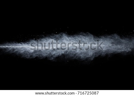 Powder explosion. Closeup of white dust particle explosion isolated on black background