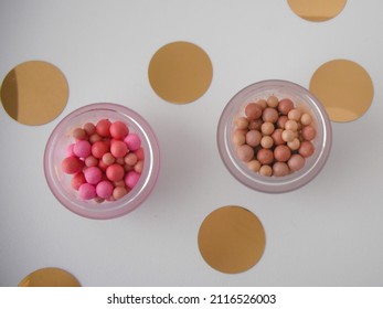 Powder Pearls For Face And Body Makeup. Luminizer, Bronzer And Setting Powder In A Glass Clear And Gold Round Packaging.