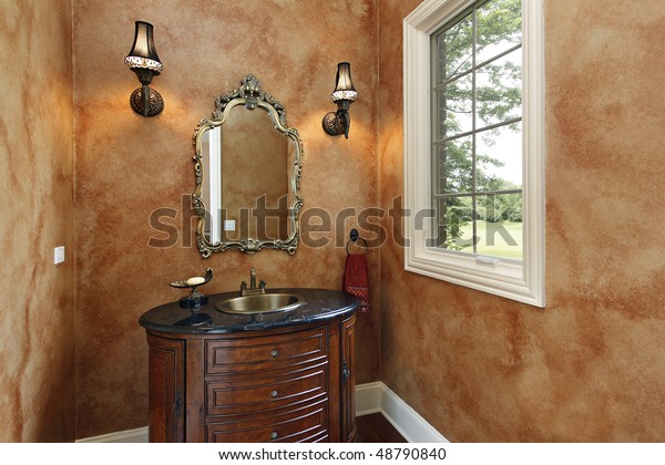 Powder room in luxury\
home with oval sink