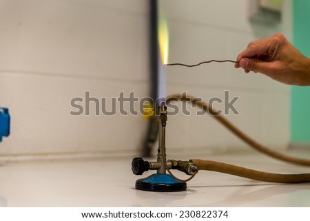powder test a Bunsen burner showing flame and hose.