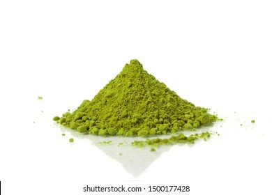 Powdered matcha green tea scattered on white background.