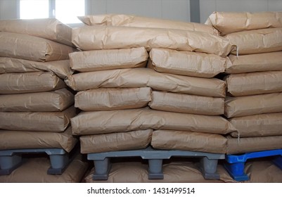 Powdered Milk In Paper Bags Stacked On Plastic Pallets, Factory Warehouse.