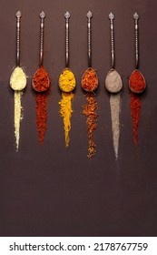 Powdered Seasonings, Spices In Spoons Close-up On A Brown Background. Copy Space For Text.