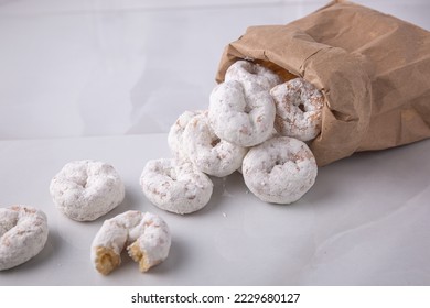 Powdered sugar mini donuts from a bag- carnival or summer fair food - Powered by Shutterstock