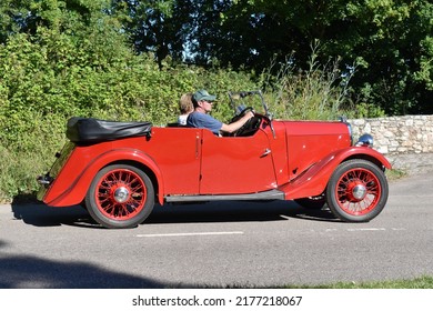 Powderham, Devon, UK. July 9th 2022. Jowett Weasel Historic Classic Car In Red. A Collectible Vintage Motorcar From The 1930's.Pictured Driving Down A Country Road On A Summers Day. 