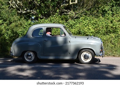 Powderham, Devon, UK. July 9th 2022. Classic Grey Austin A30  Historic Saloon Car Driving Down A Country Lane.