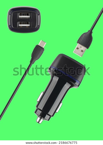 power adapter for the phone from\
the cigarette lighter, on a green background in\
isolation