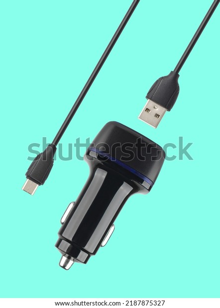 power adapter for the phone from\
the cigarette lighter, on a blue background in\
isolation