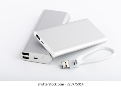 Power bank for charging mobile devices. White smart phone charger with power bank (battery bank). External battery for mobile devices. - Shutterstock ID 725975314